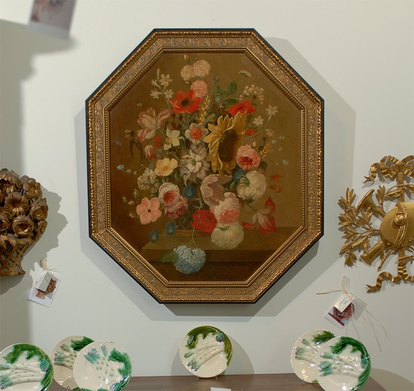 A French Restauration period octagonal framed oil on canvas still-life painting from the early 19th century, depicting a bouquet of flowers. Born in France during the reign of King Louis XVIII, this octagonal oil on canvas painting depicts a