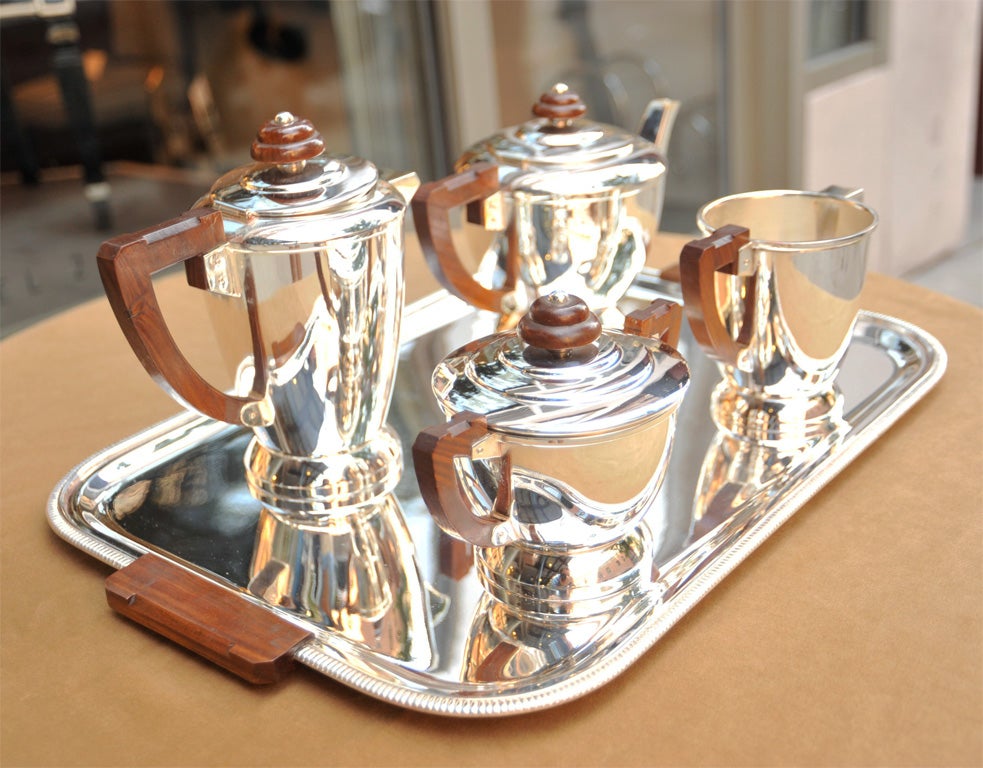5pc Set includes Coffe pot,tea pot,covered sugar bowl,creamer and tray. Stylized hive design of concentric rings create a glamourous deco design with walnut accents