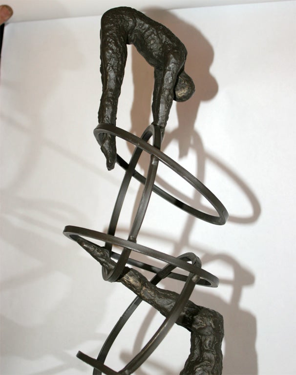 A Modernist Bronze Sculpture Man Diving thru Hoops 1