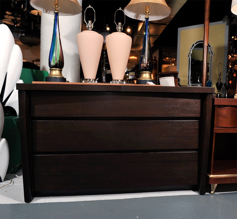 From the Distinctive Furniture Collection, modernist chest of drawers by John Cameron Furniture Company. With an indented V design top and Art Deco skyscraper elements. Modified and reinforced top to accommodate a flat screen TV. This item is now on