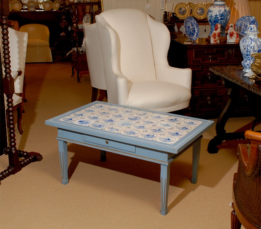 Turn of the century painted table with inset late 19th c. Delft tiles.  Table reduced to coffee table height.