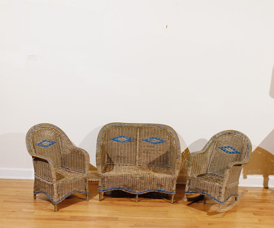 This is an adorable Child's Wicker Sofa set.   The blue paint is old but not original. The background paint is original and is a dark grey with a hint of green.  The chair is 26.25