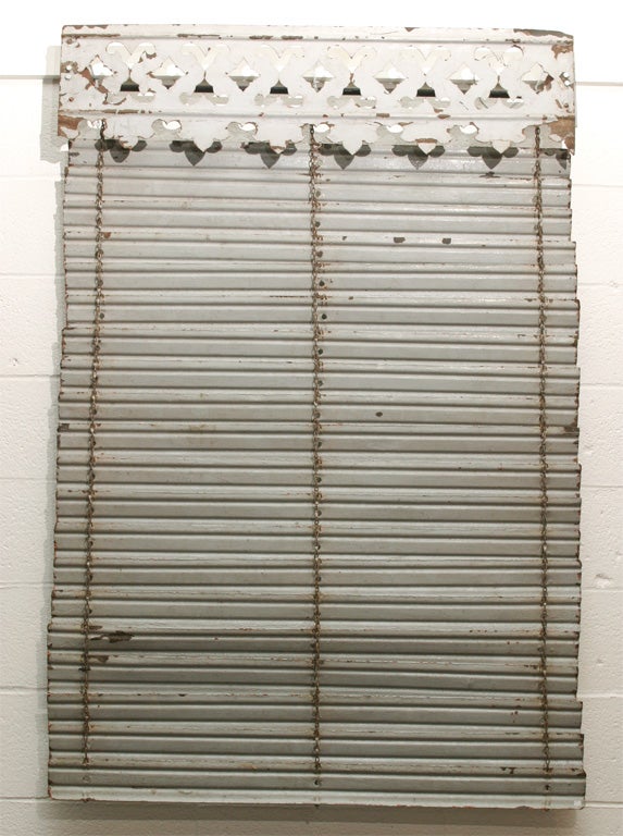 This painted iron exterior shutter is from the South of France.<br />
It has a nicely carved valance top with a bracketed attachment.<br />
The shutter has the original painted patina and would make <br />
a great decorative wall hanging or