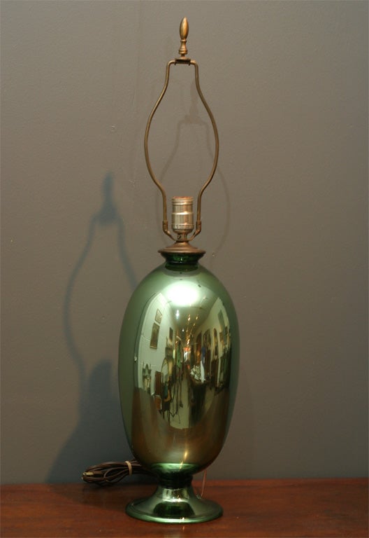 A wonderful green balloon shaped oval mercury glass lamp.<br />
The base has a unique opening in the glass for the cord.