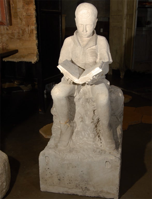 This carved stone statue of a boy was reclaimed from the gardens of a Bastide near Lyon, France.  Detailed cutwork creates a lovely sculpture of a young boy reading a book. This peaceful piece would nicely compliment a tranquil garden.