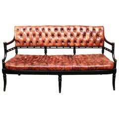 An Ebonized and Cognac Leather Tufted Settee