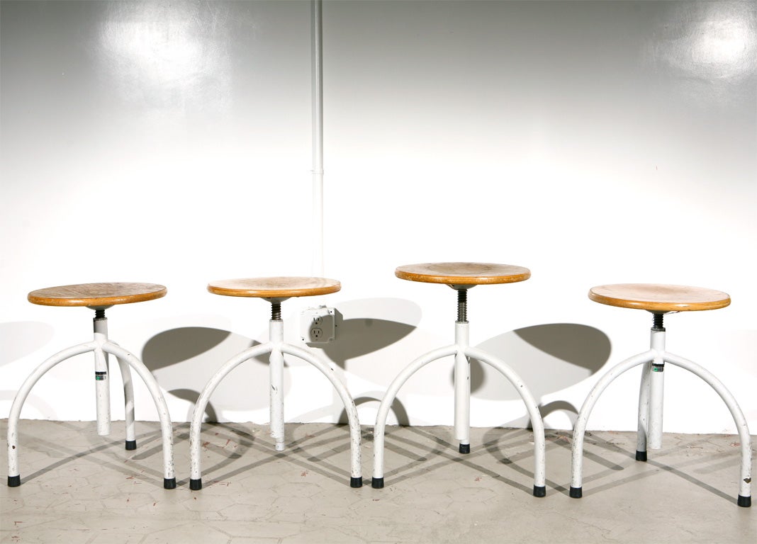 Functional and fully adjustable three-legged stools from the University Numegen in the Netherlands. These industrial stools were made by the Dutch company Oostwoud who specialize in medical furnishings. Some chairs are numbered and labeled with a