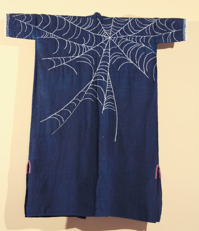 Japanese indigo dyed cotton farmer's jacket with white decorative stitching (sashiko) of spider web motif.  The spider (kumo) is symbolic of industriousness, as they are known for their beautiful and intricate webs. A rare and fine example of