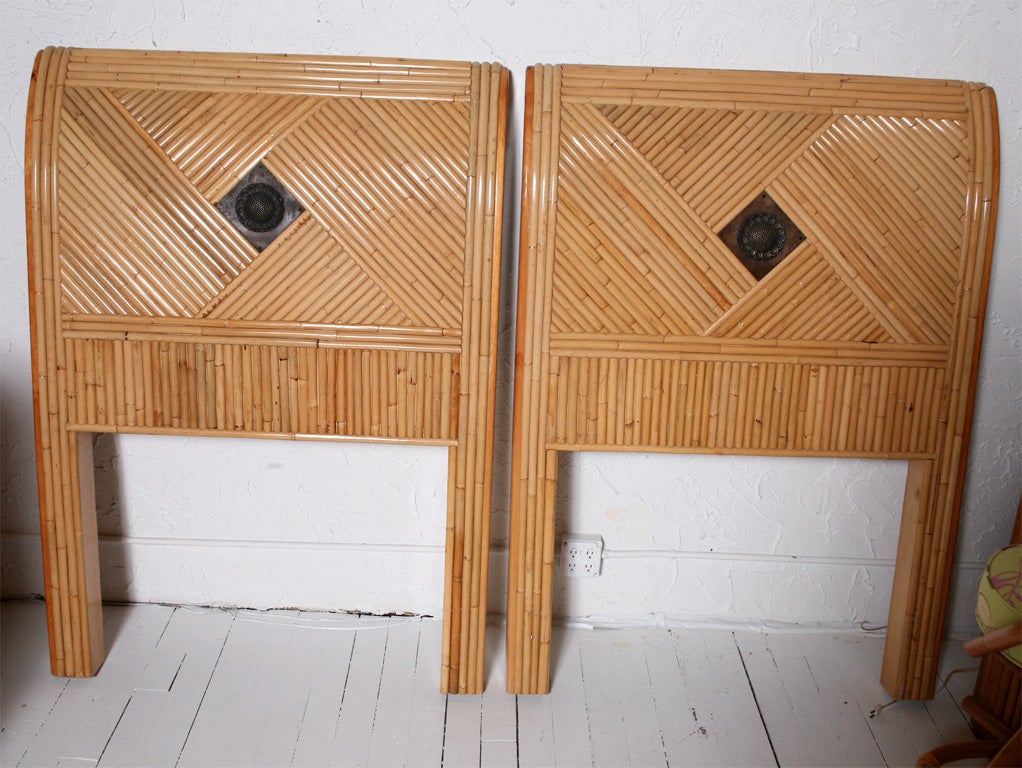 Pair of vintage rattan twin headboards with decorative insert. Quality construction. Please see our other matching pieces also listed on 1stdibs.com. ***Contact/Shipping Information: AOL (American Online) users may experience difficulties sending