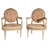 Pair of painted Louis XVI style armchairs