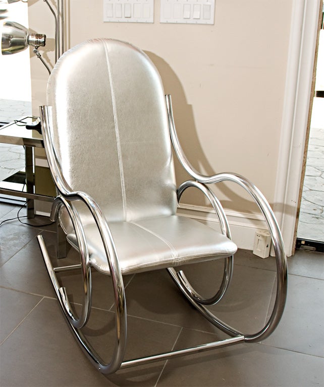Rocker with bent chrome frame upholstered in silver foiled leather with baseball stitch centered in seat and back cushion for detail<br />
Darren Ransdell Design