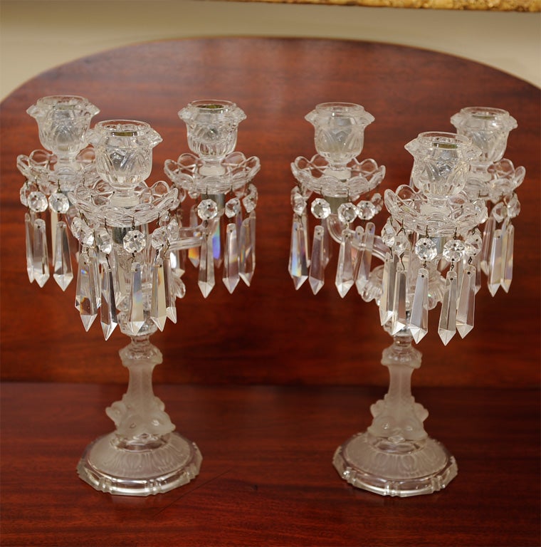 These candelabra are either Lalique or Baccarat. Molded, cut and frosted lead crystal with brass metal parts. 3 branches supported by dolphin bases. All original including pinning.