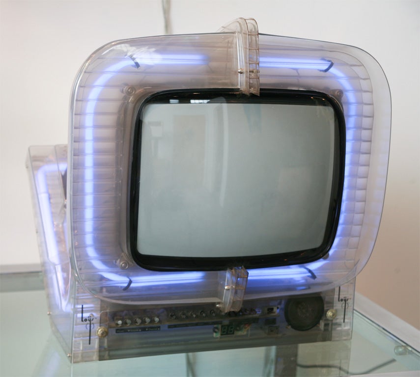 Limited edition Mitsubishi color TV in French designed (signed Loys) clear lucite with purplish blue neon surrounding the picture tube and diagonally around the chassis. About a dozen were made for Philadelphia department store Strawbridge and