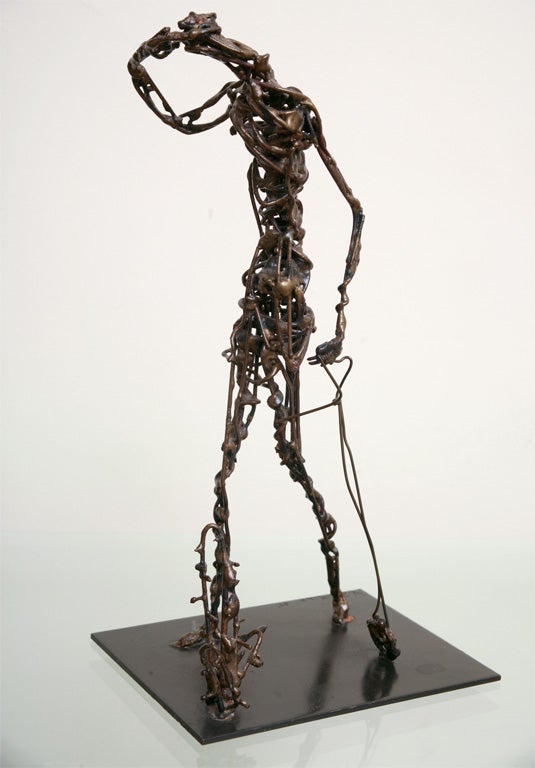 Sophisticated sculpture of abstract male form intricately made by twisting and welding long thin pieces of bronze. An additional abstract figure is also welded to the black iron base. Signature is etched into the base with the year. Mr Zaikine