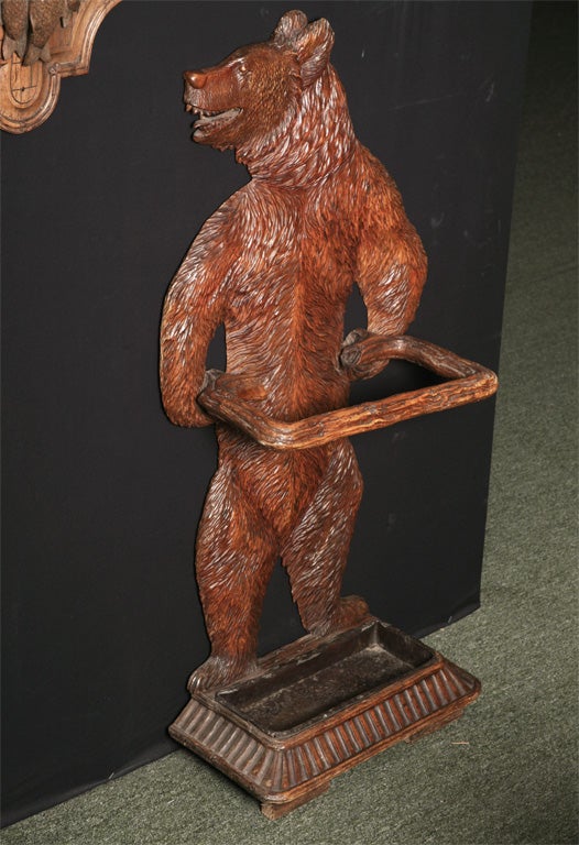 A Black Forest carved stick stand