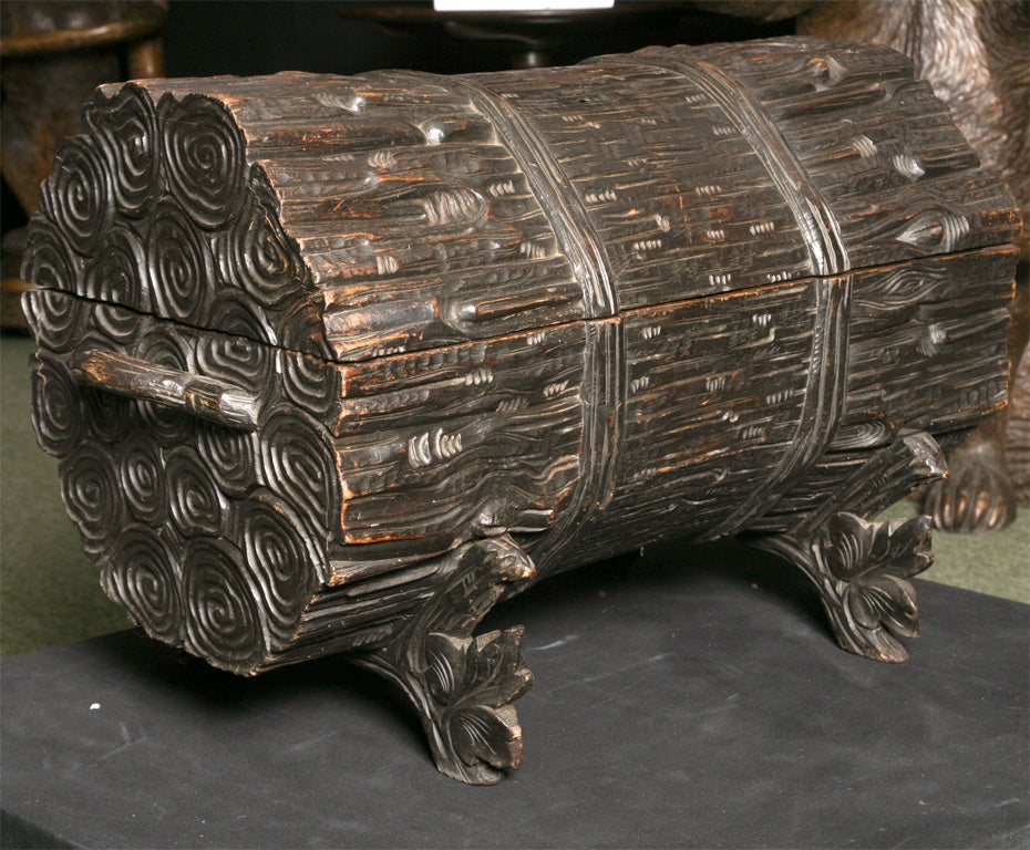 A Black Forest carved log box.