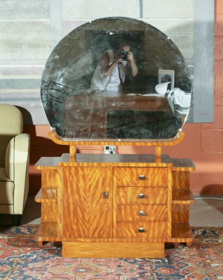 Art Deco vanity with large, circular mirror. Multiple shelves and cabinetry. A fine example of Art Deco in a wonderful burl wood finish.