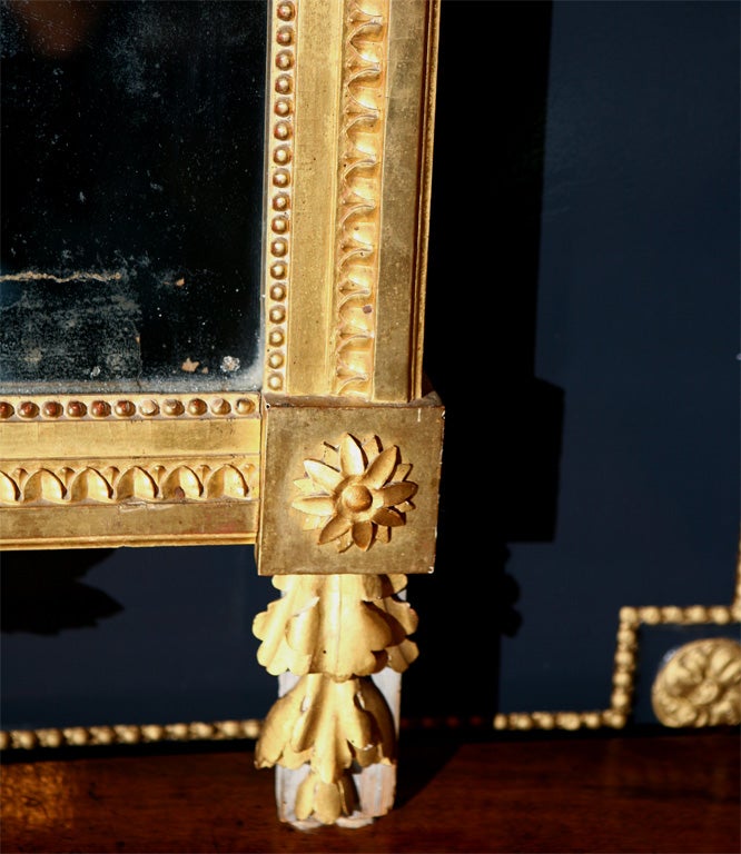 French Louis XVI Giltwood Mirror with Original Glass Plate Surrounded by Laurel Leaves, Beading, Egg & Dart Motif, Topped by a Beautiful Crest with Helmet and Feather Plume.