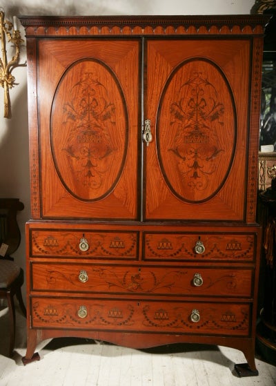 a beautifully inlaid linen press, the top opening to reveal an open space that originally had  shelves. above  2 short  drawers and 2 long drawers. topped  by carved drop moldings