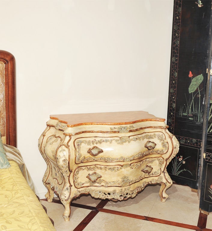Venetian style:hand carved and hand painted ,reproduction of XVII commode, with drawers ,extensive hand carved delicate and intricate flower motif with shell shaped handles . Faux Marble top.
