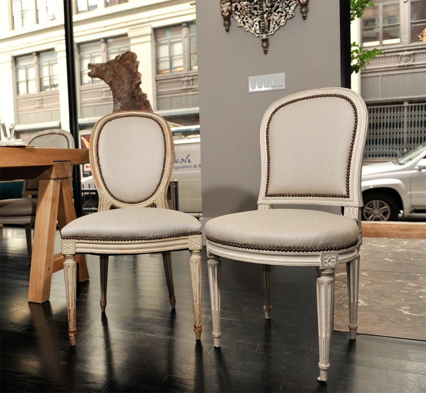 Dining Chairs with Painted Frame and Grey Linen Upholstery<br />
This set combines two really unique sets of chairs from the 18th Century and 19th Century respectively. They have the same scale and make a fantastic set of twelve. They have been