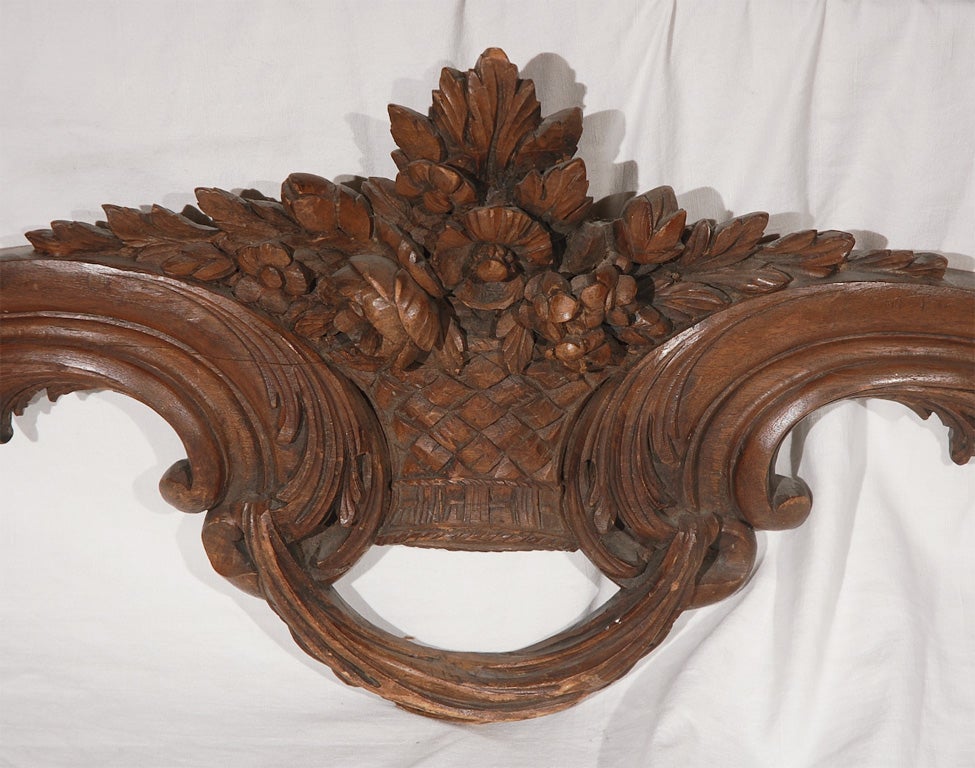A finely carved basket of flowers is flanked by two scrolls with acanthus leaf detailing.  This piece would be perfect over a window or doorway.  I have also made wonderful custom headboards out of similar architectural pieces.