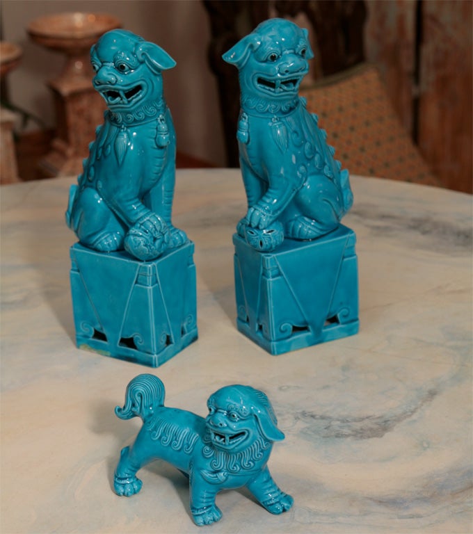 This charming Foo Dog Family is glazed in a beautiful turquoise finish. The parents are mounted on stands and the puppy is free form. The intimate scale and happy expression make this a great set.