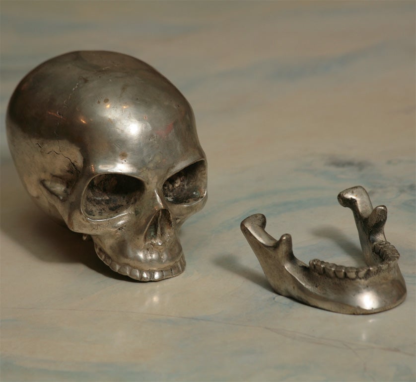 A wonderful memento mori, this skull is made of solid brass with a nickel over plate. <br />
It reticulates and the jawbone is removable.<br />
It is marked Summit and has an unrecognizable signature.