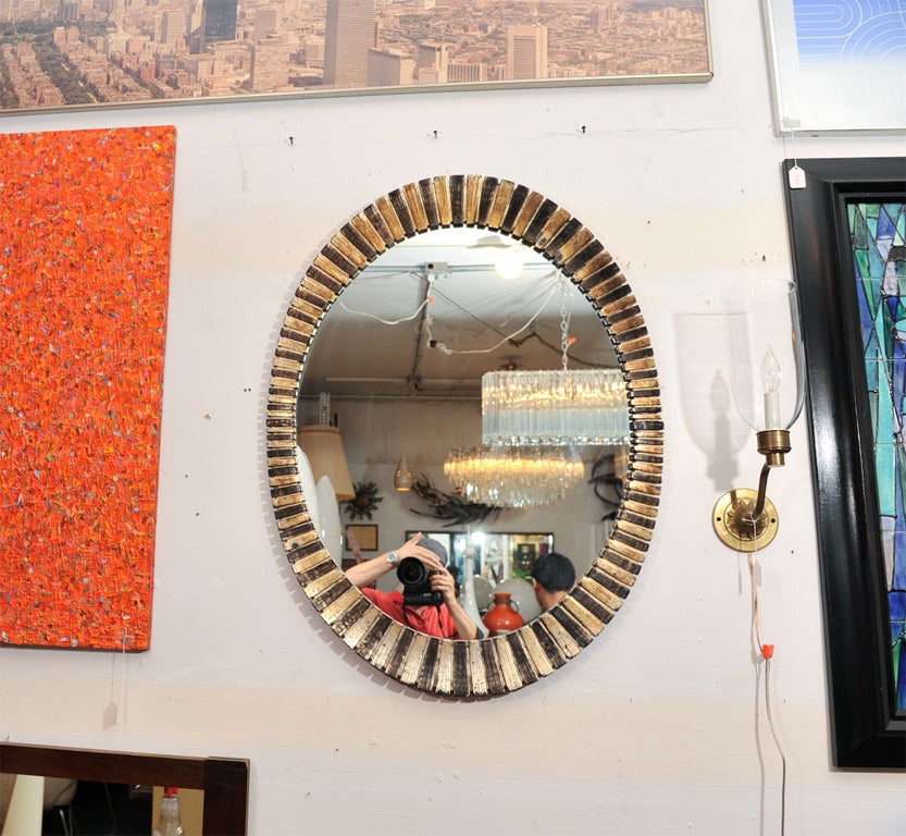Beautiful decorative modern cast resin oval mirror with silver leaf and gray patina finish.  Please contact for location.