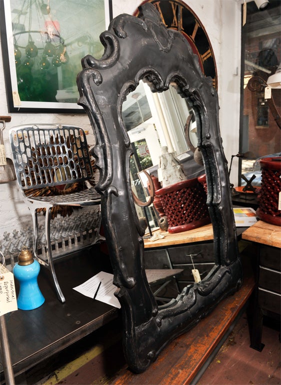 Spanish Baroque style mirror with blackened metal frame.