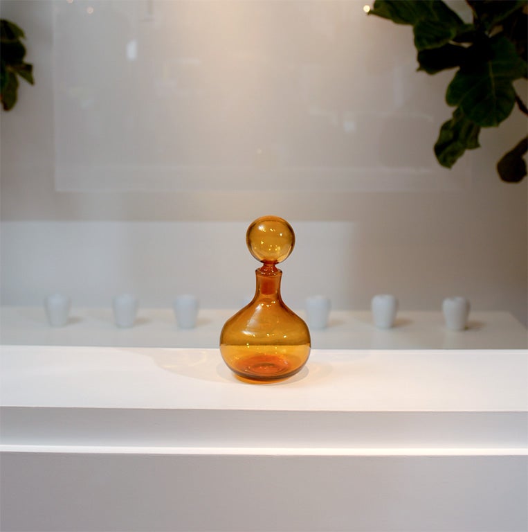 * Vintage<br />
* Hand blown<br />
* Beautiful rounded shape<br />
* Amber colored glass<br />
* Round glass ball stopper
