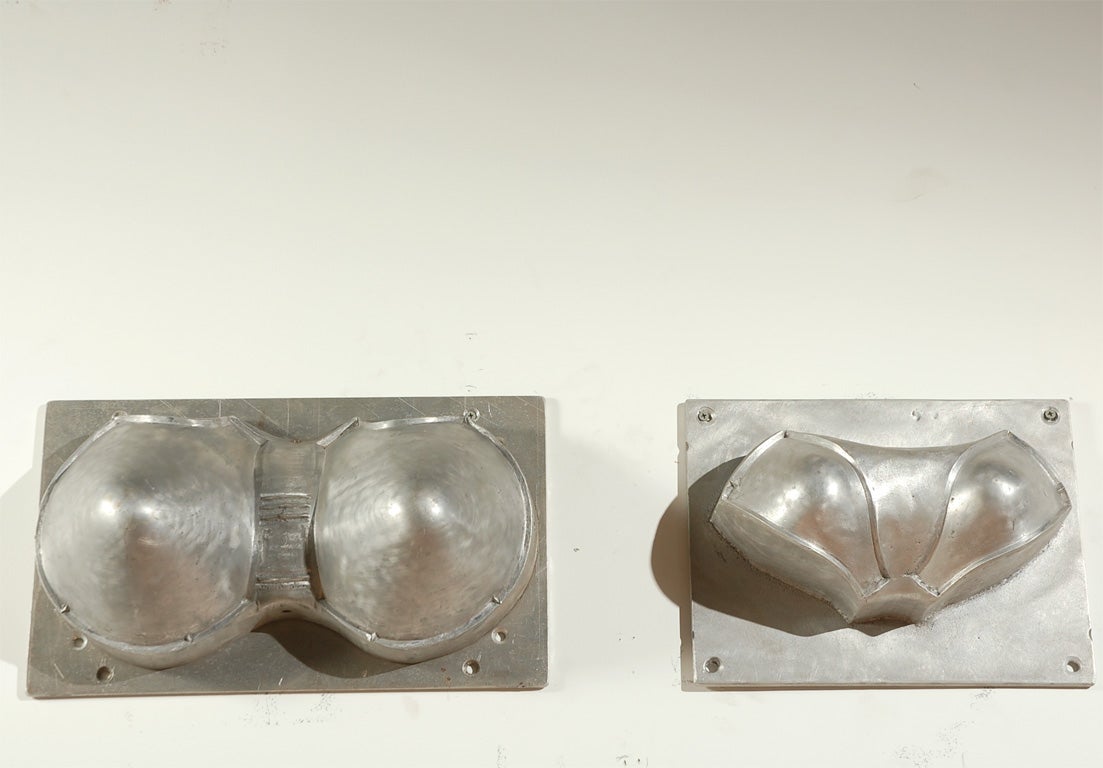 Industrial bra mold forms.  Great wall hangings.  The larger set is 16" wide by 9.5" tall by 7" deep.  The smaller set is 12.5" wide by 9.5" tall by 6" deep.  Priced per set.