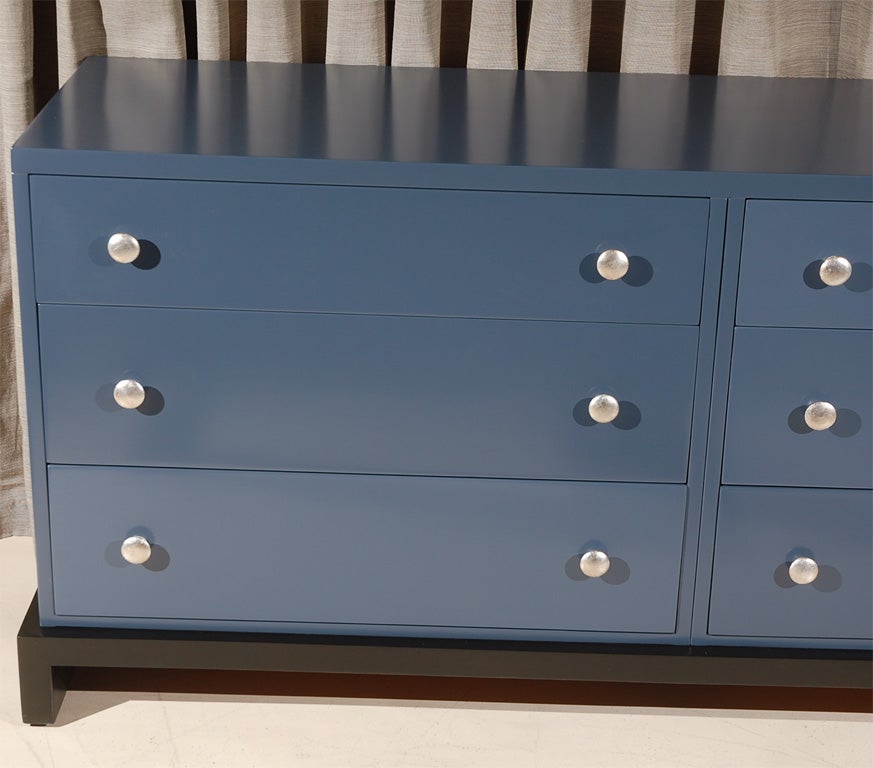 Grey-Blue lacquered six-drawer dresser design by TH Robsjohn Gibbings for Widdicomb.  Black lacquered platform base with silverleafed knobs.