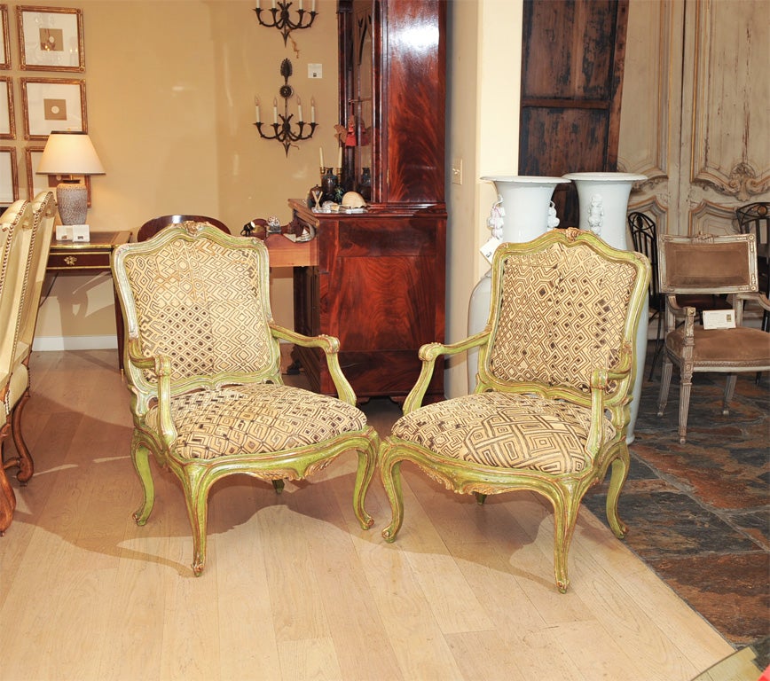 Pair of Hand carved Venetian Style Rococo Painted and Parcel Gilt Armchairs Upholstered in Antique Kuba Velvet Textiles.