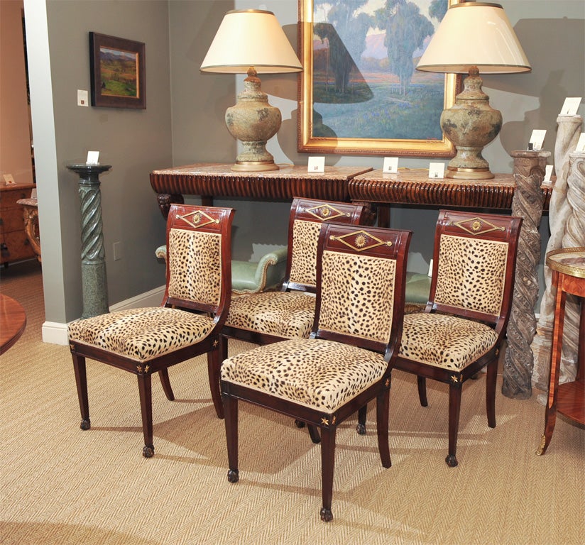 A Set of Four Beautiful French Empire Mahogany Side Chairs With Gilt Bronze Rosettes Upholstered on Seats and Backs in Faux Cheetah and Culminating In Claw & Ball Feet.