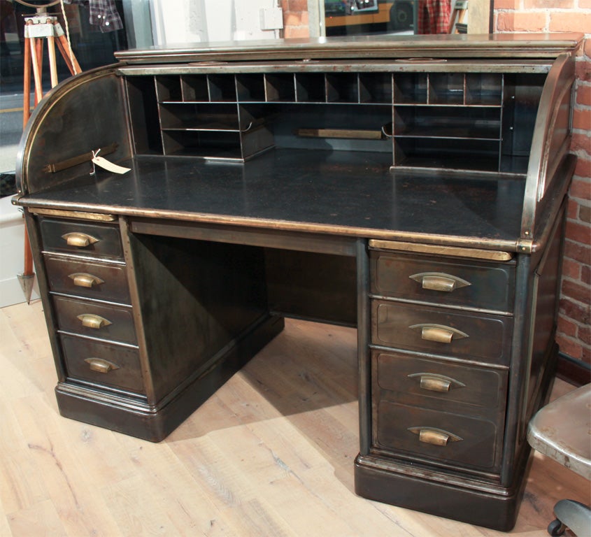 The roll top desk was made early 1900's by the Art Metal Company Canton, Ohio.  They were the manufacturers and designers of steel interior construction and commercial furniture for banks, offices and public buildings.  Designed after many fires in