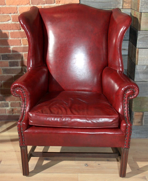 50's vintage red vinyl wing back chair with furniture tack detailing. Very regal.