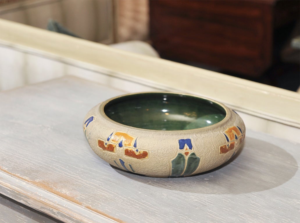 Egyptian inspired Mostique bowl from Roseville. Raised exterior in brilliant colors, glazed interior.  Ink stamped in blue (chipped).