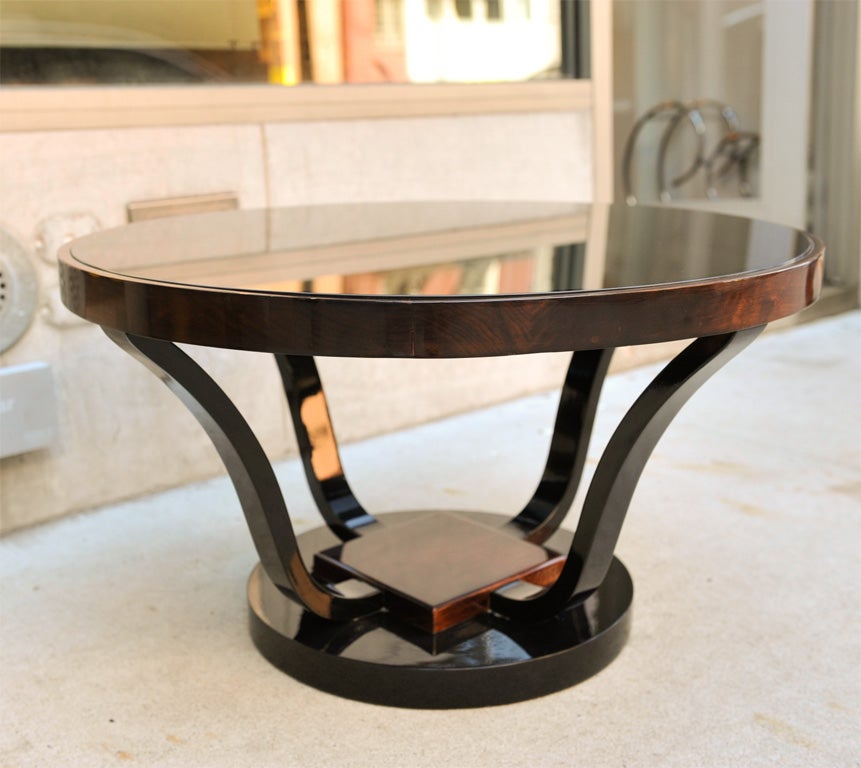 Walnut and black lacquered<br />
cocktail table with stepped<br />
pedestal base. Has a stylized<br />
design and a round smoked <br />
glass table top. Makes a <br />
great occasional table<br />
as well.