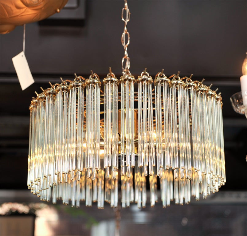 Simple yet chic chandelier made<br />
of glass rods in varying lengths,<br />
with both brass and chromed <br />
fittings.  Fitted with five <br />
lights and with chain link<br />
for adjustable lengths.