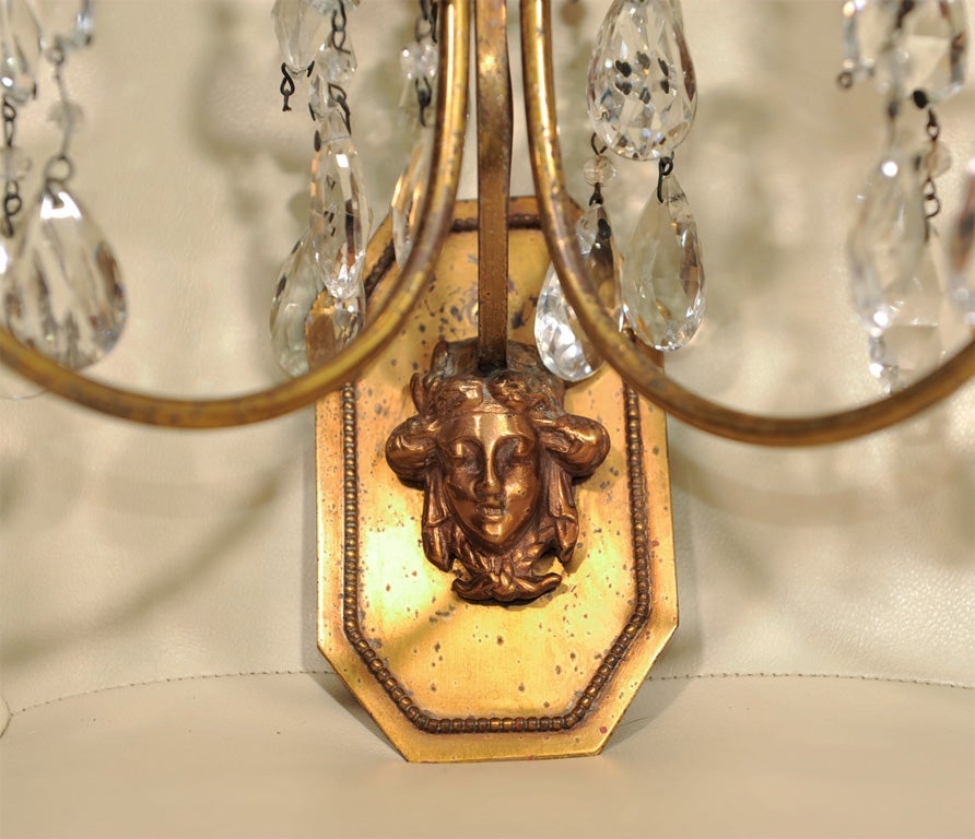Elegant bronze and crystal sconces have been rewired and have a face detail.