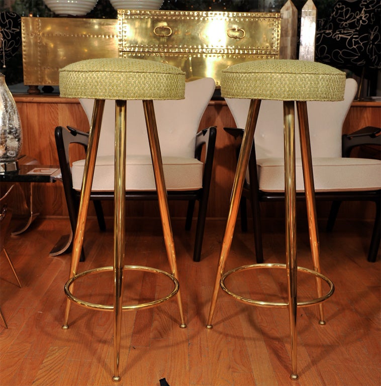 Upholstered brass tripod stools. Currently upholstered in white (not shown).