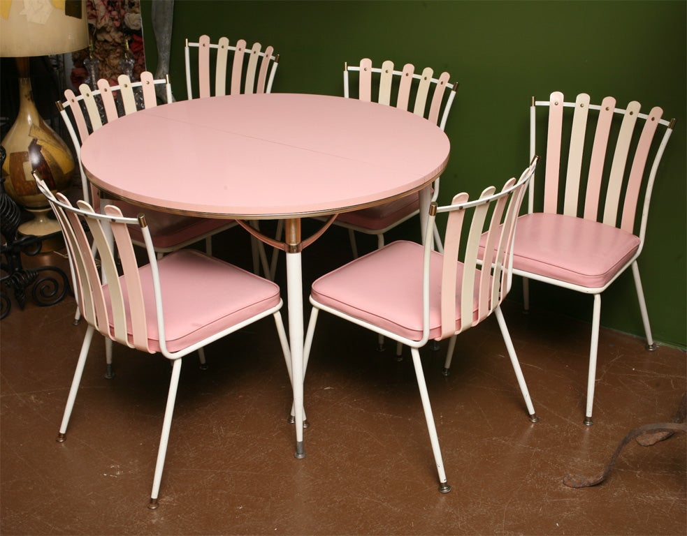 This rare Daystrom dinette set is as fabulous 60's as it gets!The legs of the table and the six chairs have tiny gold fleck accents. The strapping on chairs is alternating pink & white lucite. (The table also has an additional leaf to extend the top