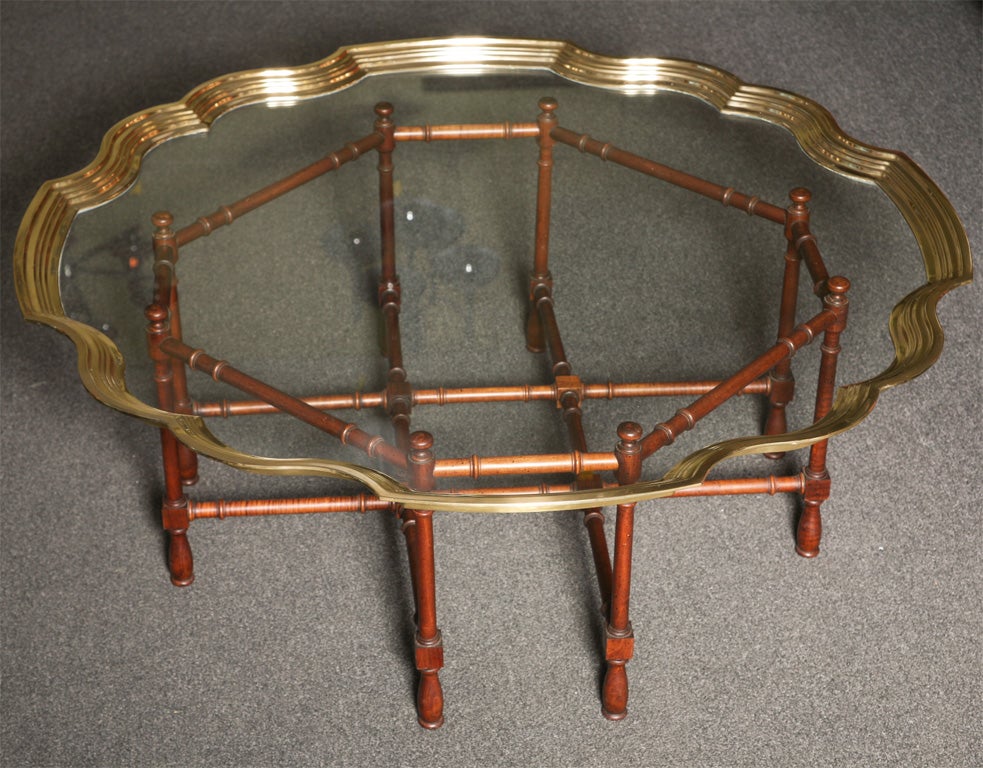 SOLD MARCH 2010...Very fine & elegant molded brass and glass coffee table with a Chippendale style turned wood octagonal base.  Glorious deep pie crust shaped heavy brass framing the glass, exceptionally well made.  In the oriental taste turned wood