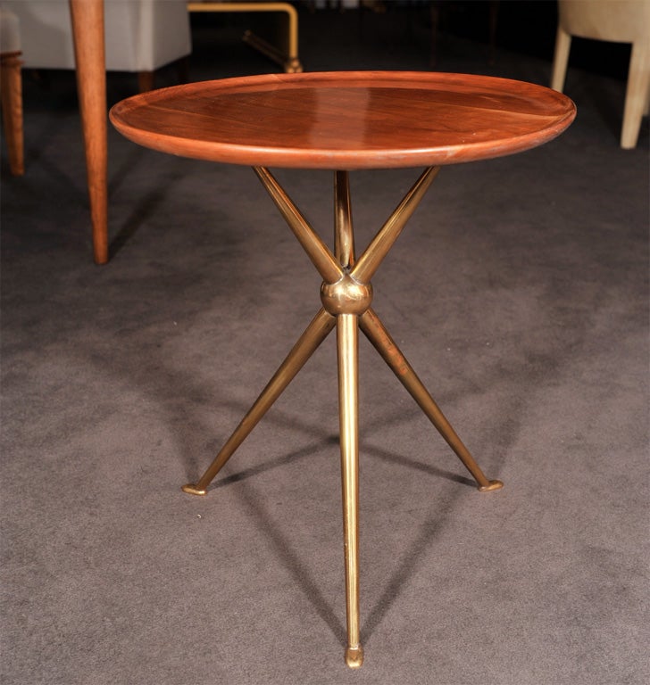 A pair of wild cherry side tables raised on brass tripod bases<br />
attributed to Osvaldo Borsani (1911-1985)<br />
<br />
Provenance:  Olivier Watelet, Paris