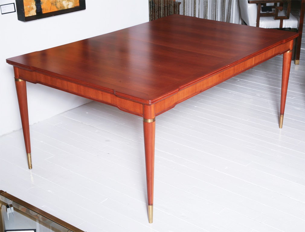 Fine & rare John Widdicomb dining table in cherry with brass accents designed by J. Stuart Clingman. Please see the matching chairs also listed on 1stdibs.com.  ***Contact Information: AOL (American Online) users may experience difficulties sending