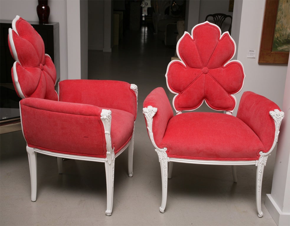 White lacquer armchairs with flower motif backrest upholstered in hot pink velvet.