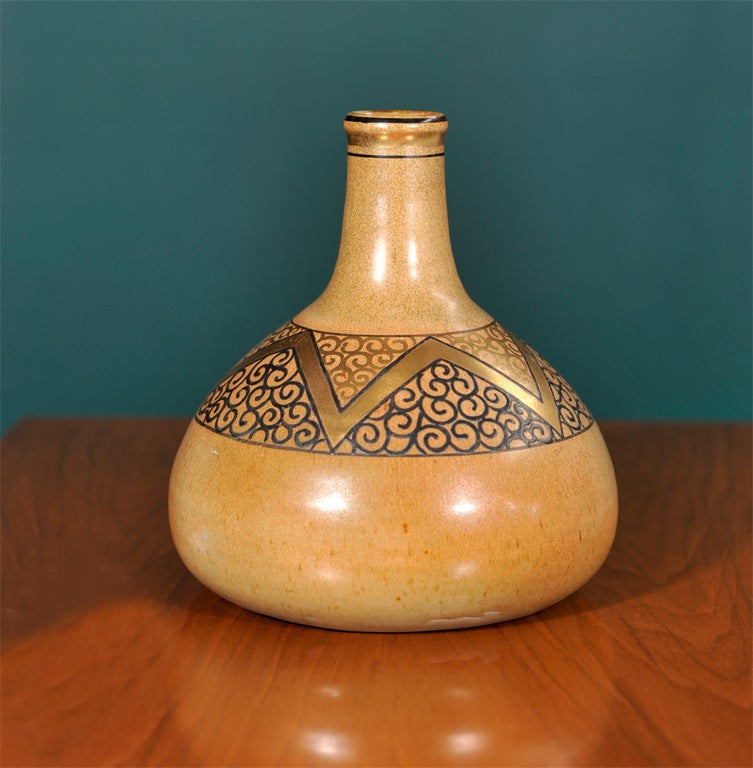 Ceramic bottle-form vase by Jean Luce, French 1925.  The base is decorated with linear patterns in gold and black.

7 1/2 