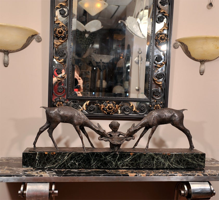 A black patinated bronze group “Two Deer and Faun” by Ary Bitter (French, 1883-1973), from circa 1925. Signed and with foundry mark, “Susse Frères” on the bronze plinth. Mounted on a green marble base.