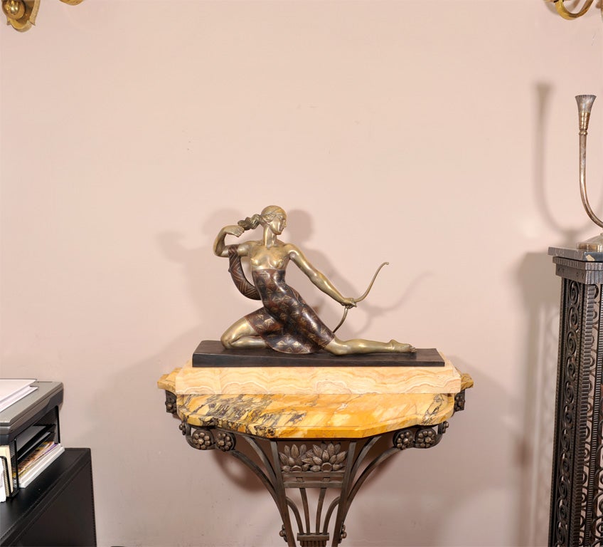 A French Art Deco archer figure, “Diana the Huntress” by Joseph Descomps (born J.E. Cormier, French, 1869-1950), from c. 1928. Silvered and enamelled bronze, mounted on a yellow onyx base. Signed in the bronze.
